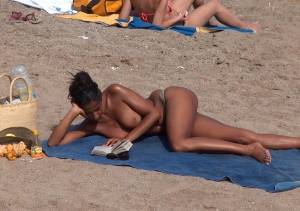topless-babe-reading-at-beach